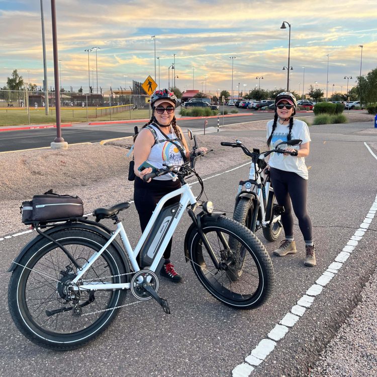 Women riding Smittys E-Bikes, stylish electric bikes for leisure and commute.