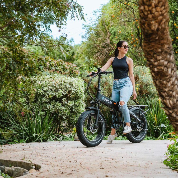 woman in black tank top with sunglasses riding on an electric bike